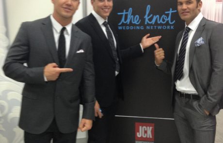 brand launch 3 men in suites in front of a banner that says the knot.